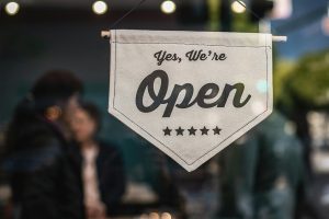 Best Small Business Marketing Agency Serving the Treasure Coast an Open Sign Hanging in a Window of a Store