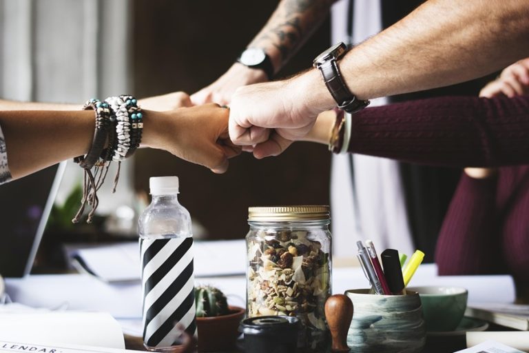 Best Small Business Marketing Company in Palm City Florida Close Up of a Team of Employees Bumping Fists