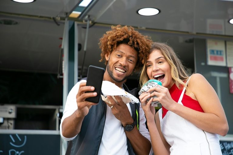 Best Small Business Marketing Company in Jupiter Florida Two People Taking a Selfie with Some Food From a Food Truck Behind Them