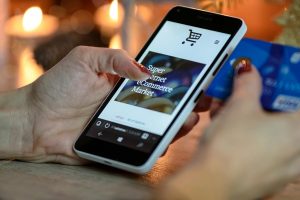 Where to Find the Best Small Business Marketing Services in Stuart Florida Close Up of a Person's Hand Holding a Phone with a Store's Website On the Screen