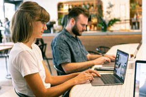 Best Small Business Marketing Company in Port Salerno Florida Two People Working on Laptops at a Desk in an Office