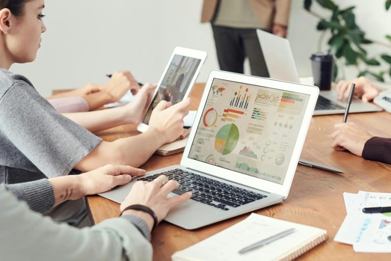 Best Small Business Marketing Company Jensen Beach Florida People in a Meeting with Laptops Showing Graphs