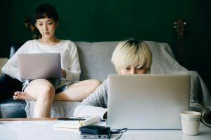 Best Google Business Profile Marketing Agency in Hutchinson Island Florida Two People in a Living Room Looking at Laptops