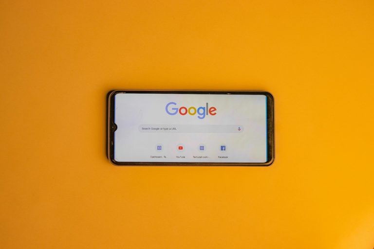 Best Google Business Profile Marketing Agency in Hutchinson Island Florida a Smartphone with Google on the Display on a Yellow Surface