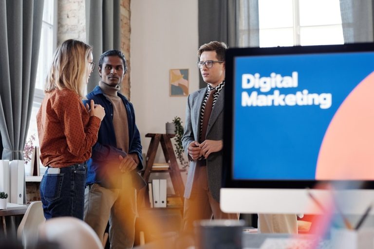 Best Small Business Marketing Services in Treasure Coast a Computer Screen That Says Digital Marketing with a Group of People Standing Together and Talking in the Background
