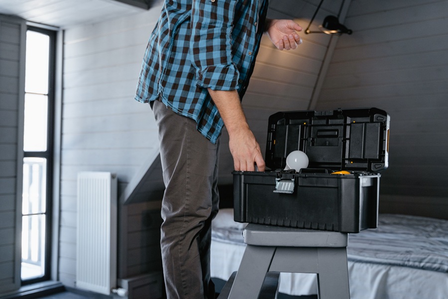 Home Services Marketing in Jupiter Florida a Man Standing Over an Open Toolbox in a Room