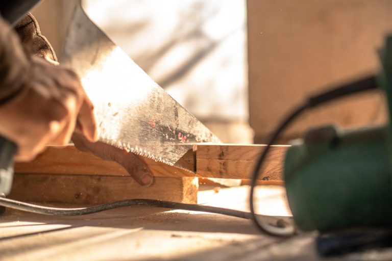 Home Services Marketing in Jupiter Florida Close Up of a Handsaw Being Used to Cut Wood