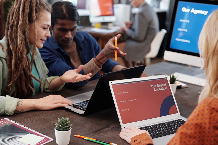 Best SEO Services for Sewalls Point People Having a Business Meeting in an Office with Laptops and Desktops