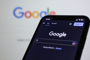 Best SEO Services for Stuart Florida a Phone with Google on the Display and a Computer Display in the Background That Also Says Google