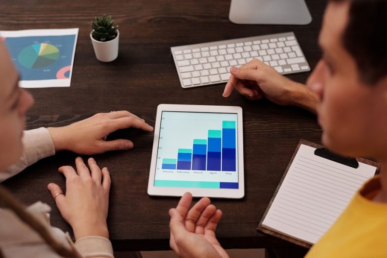 Best SEO Services in Treasure Coast Two People Looking at a Growth Bar Chart on a Tablet
