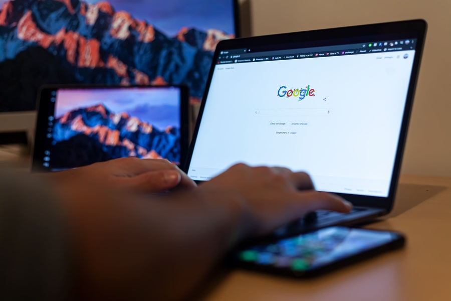 SEO Marketing for Home Service Businesses in Palm City Florida a Person Sitting at a Table with a Laptop Searching on Google
