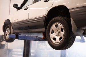SEO Services for Trade Companies in Stuart Florida a Car Lifted into the Air on a Lift in a Mechanic Shop