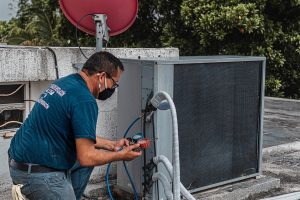 SEO Services for Trade Companies in Stuart Florida an HVAC Specialist Working on an AC Unit